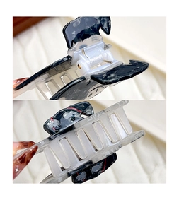 Detail of high-strength metal spring and dalmatian pattern hair claw clip for women