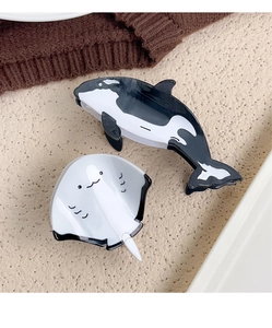 Detailed close-up of whale and stingray acetate hair claws for stylish women