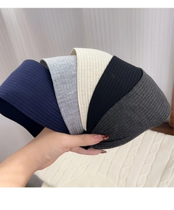 Detailed texture of rib-knit headbands in navy, grey, beige and black fabrics