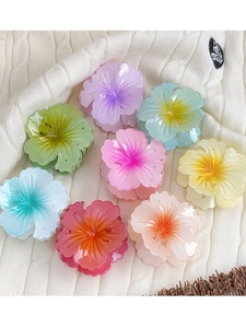 Detailed view of colorful hibiscus flower hair claws in assorted matte resin shades