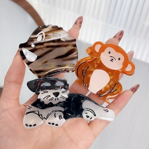 Three animal-shaped acetate hair claws including Schnauzer and monkey designs for women