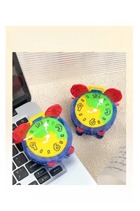 Detail showing two colorful clock-shaped acetate hair claws on a laptop and carpet