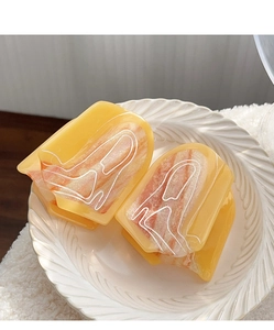 Close-up of amber marble hair claws with resin texture on a white decorative tray