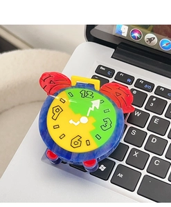 Close-up of a colorful clock hair claw clip made of acetate on a laptop keyboard