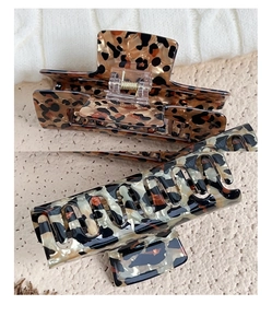 Detail view of large leopard print hair claws with durable gold metal springs