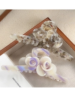 Detail of rose hair claws with elegant marble texture in vintage aesthetic