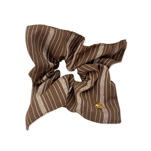 Striped brown fabric hair scrunchie with retro pattern and small gold heart charm