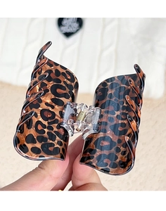 Close-up of large leopard print hair claw clip showing amber tortoiseshell texture