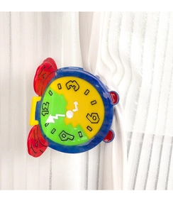 Macro detail of colorful clock-shaped acetate hair claw clip on white curtain background
