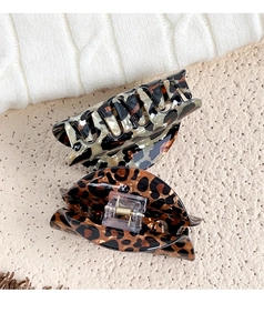Detail of large leopard print hair claws in rectangle and oval shapes made of resin