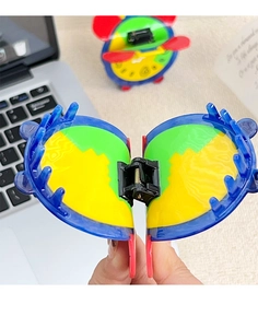 Macro view of a colorful alarm clock hair claw clip showing spring mechanism and acetate design