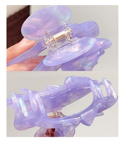 Detail of the purple iridescent acetate claw clip showing metallic spring and grip