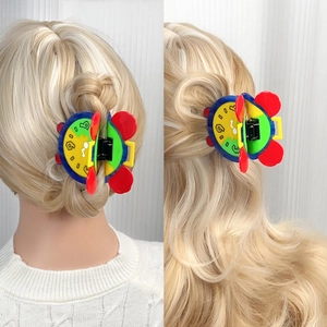 Colorful clock-themed acetate hair claw clip with pop art style and bold contrast colors