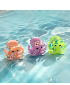 Close-up of marble texture acetate octopus hair clips in pink, purple, and green shades