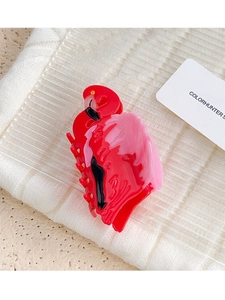 Detail view of pink and red flamingo-shaped hair claw clip made of glossy acrylic