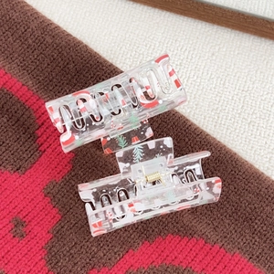 Clear acrylic Christmas hair claws with Santa Claus and tree prints in a two-piece set
