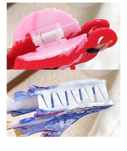 Detail view of acetate hair claw clips showing sturdy metal spring and non-slip tooth design