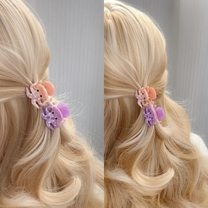 Cute octopus acetate hair claws for kids in pink and purple on blonde wavy hair