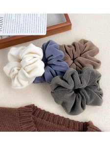 Set of four plush fleece scrunchies in cream, blue, brown, and grey colors