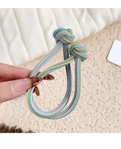 Detailed view of colorful striped elastic hair ties with decorative knots and texture