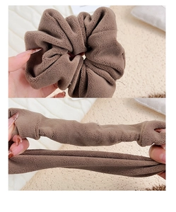 Detail showing elastic stretch and soft plush texture of the coffee brown hair scrunchie