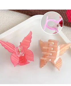 Detail view of 3mm thick acrylic butterfly hair clips in pink and orange colors