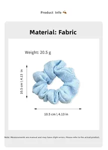 Macro shot of light blue scrunchie showing detailed textured fabric and 10.5cm diameter