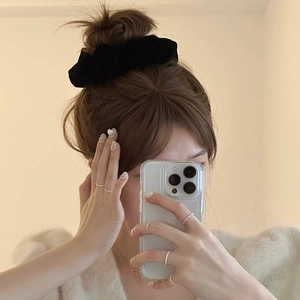 Elegant black velvet scrunchie and minimalist silver pearl rings worn by model