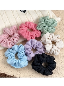 Close-up of 7-piece tweed scrunchies set in assorted pastel colors for autumn winter