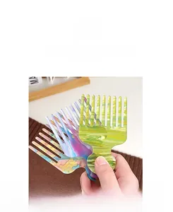 Detail of colorful marble acetate wide tooth comb with ergonomic handle for hair styling
