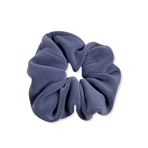 Soft purple faux fur scrunchie with plush velvet texture for women's hair styling
