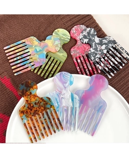 Detail of multi-color marble and tortoiseshell acetate hair combs on textured knit fabric