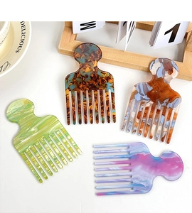 Macro shot of 4-color marble texture acetate wide-tooth combs for curly hair styling