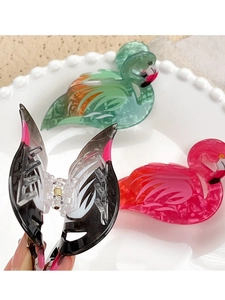Detail view of colorful acrylic flamingo hair claws in pink, teal and marbled patterns