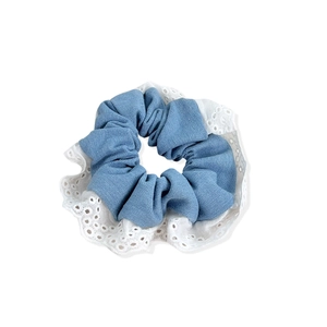 Blue denim scrunchie with white lace edges for ballet-style hair styling accessories