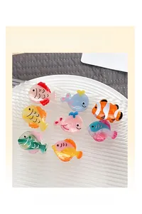 Detail of 8-piece ocean life acetate hair claws featuring vibrant fish designs for women