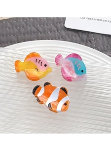 Detailed set of three colorful acetate fish-shaped hair claws for girls on a white tray