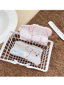Detailed view of two acrylic dog-shaped hair claws with pink and blue cartoon outlines