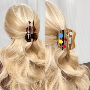 Artistic cello and palette shape acetate hair claws for women on blonde wavy hair