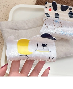 Detailed view of three cartoon puppy hair claws made of high quality acetate material