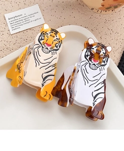 Detail of tiger-shaped acetate hair claws in orange and tortoiseshell patterns