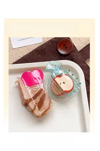 Close-up of acetic acid hair claw clips in heart cone and apple shapes on a tray