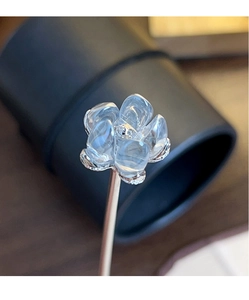 Macro shot of clear glass camellia petals and silver metal hair stick for Hanfu
