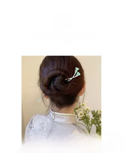Detail of silver hairpin with green lotus buds and vintage Chinese hair styling