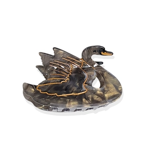 Elegant swan-shaped acetate hair claw clip with black marble texture and gold accents