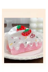 Detailed shot of strawberry cake shaped hair claw clip made of pink acetate material