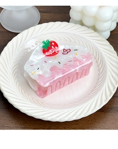 Detailed view of creative strawberry cake hair claw clip on white decorative plate