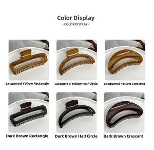 Detailed close-up of large wooden texture hair claws in amber and dark brown colors