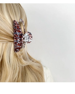 Detailed view of a marble texture hair claw clip styled on blonde hair for updos