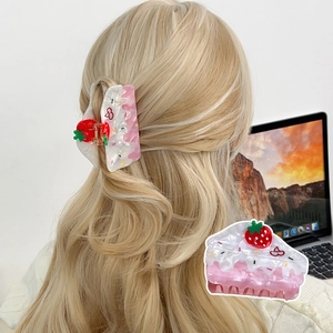 Sweet pink strawberry cake hair claw clip for women's hairstyles in a lifestyle setting